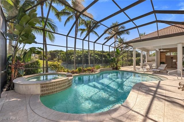 view of pool featuring a patio area, a pool with connected hot tub, glass enclosure, and a ceiling fan