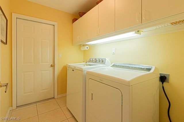 2109 Morning Sun Ln, Naples, FL 34119 - clothes washing area featuring baseboards, washer and dryer, cabinet space, and light tile patterned floors