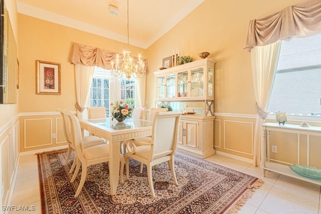 2109 Morning Sun Ln, Naples, FL 34119 - dining space with a notable chandelier, lofted ceiling, a decorative wall, and light tile patterned floors