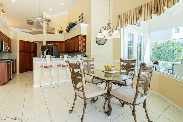 2109 Morning Sun Ln, Naples, FL 34119 - dining room with crown molding, a high ceiling, baseboards, light tile patterned floors, and ceiling fan with notable chandelier