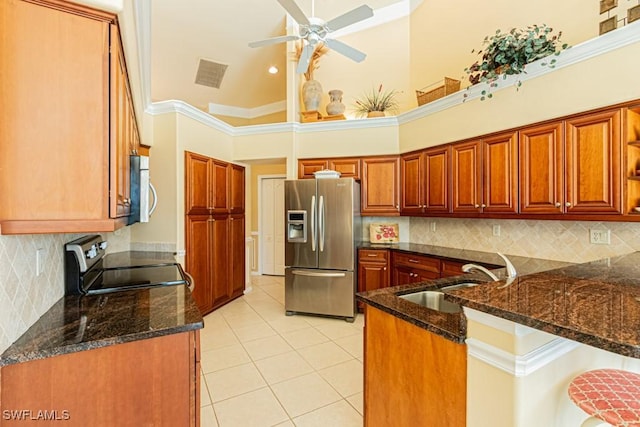 2109 Morning Sun Ln, Naples, FL 34119 - kitchen featuring a sink, a peninsula, dark stone countertops, stainless steel appliances, and visible vents