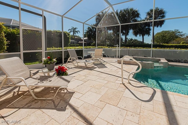 2109 Morning Sun Ln, Naples, FL 34119 - view of swimming pool with glass enclosure, a pool with connected hot tub, and a patio