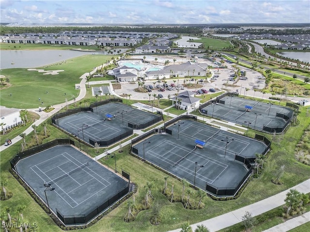 aerial view with a water view, view of golf course, and a residential view