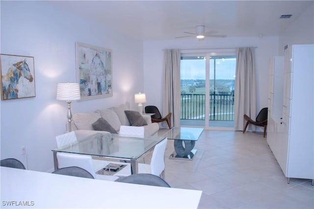 living room featuring ceiling fan and visible vents