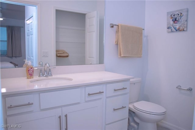 bathroom featuring toilet and vanity