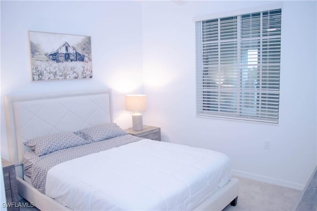 bedroom with carpet floors and baseboards