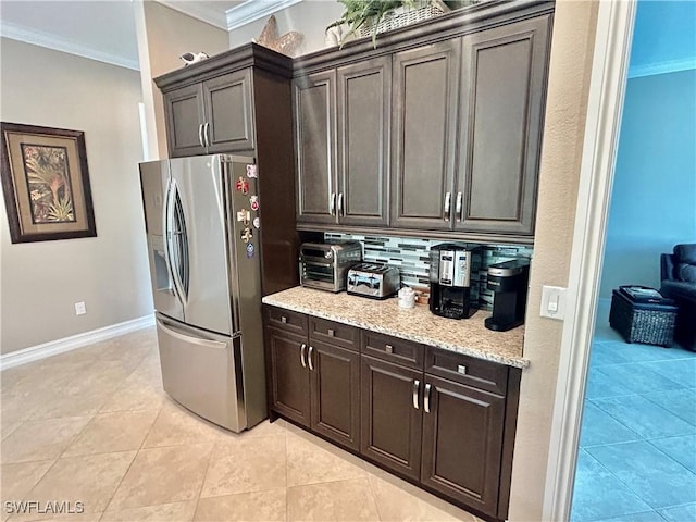 kitchen with crown molding, decorative backsplash, dark brown cabinetry, and stainless steel fridge with ice dispenser