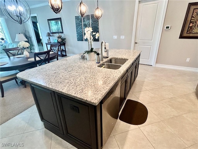 kitchen with crown molding, light tile patterned floors, hanging light fixtures, a sink, and light stone countertops