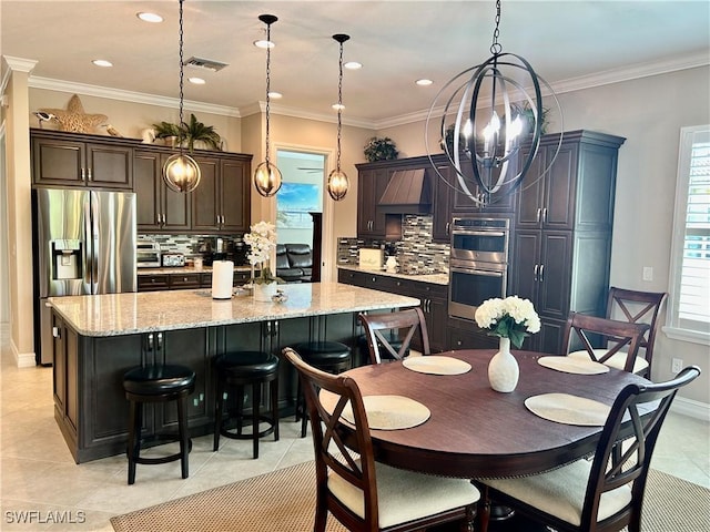 dining area featuring light tile patterned floors, crown molding, visible vents, baseboards, and an inviting chandelier