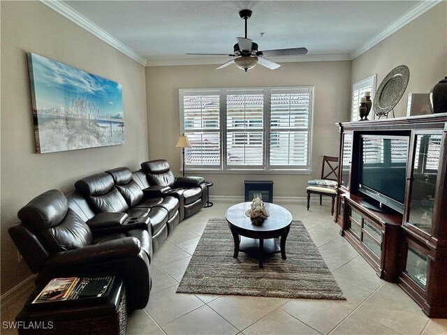 living room with light tile patterned floors, baseboards, ornamental molding, and a ceiling fan