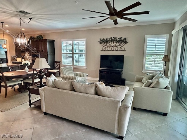 living area featuring ornamental molding, visible vents, and a healthy amount of sunlight