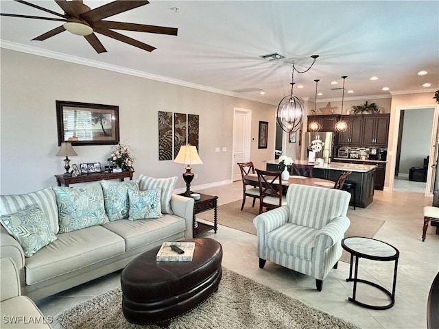 living area with ornamental molding, visible vents, and a notable chandelier