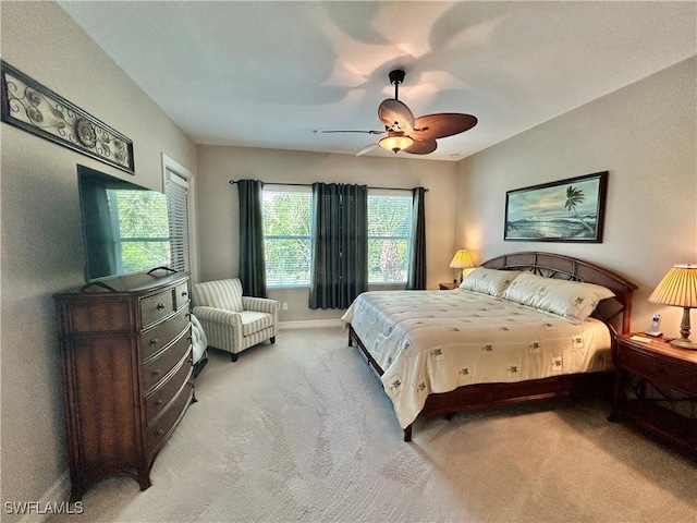 bedroom with a ceiling fan, carpet, and baseboards