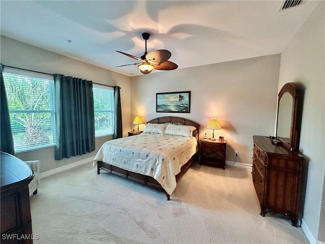 carpeted bedroom featuring visible vents, ceiling fan, and baseboards