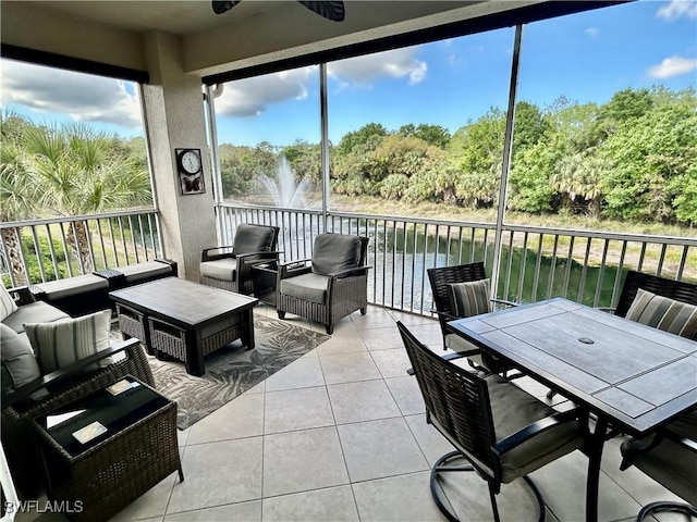 sunroom / solarium featuring a water view