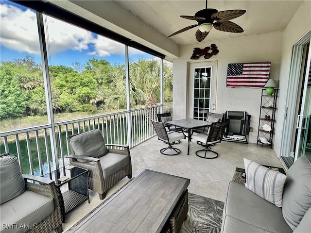 sunroom / solarium with a ceiling fan