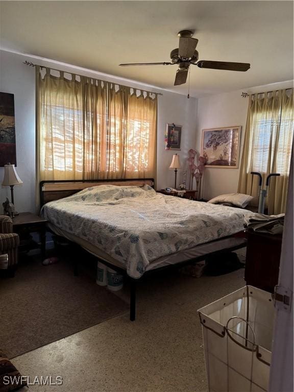 bedroom with ceiling fan and speckled floor