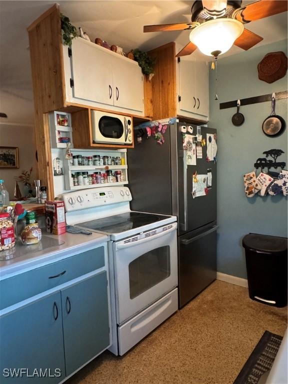 kitchen with freestanding refrigerator, speckled floor, white electric range oven, and a ceiling fan