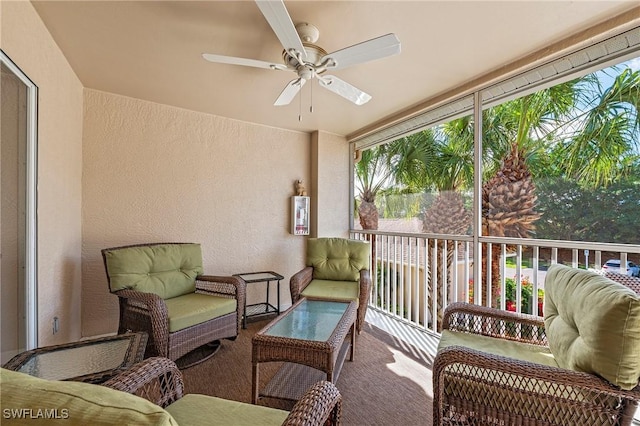 sunroom / solarium featuring a ceiling fan