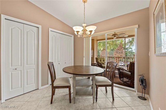 dining area with vaulted ceiling, light tile patterned floors, ceiling fan with notable chandelier, and baseboards