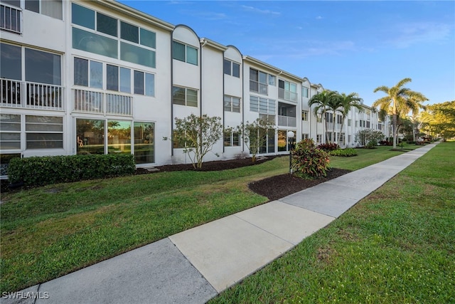 view of property's community with a residential view and a lawn