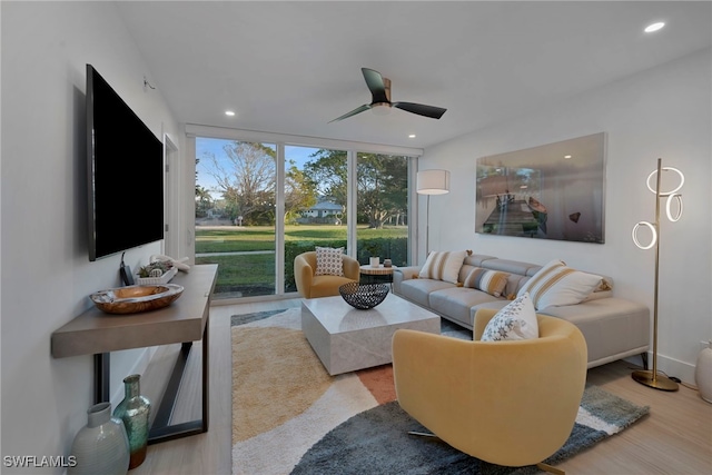 living room featuring ceiling fan, recessed lighting, wood finished floors, and floor to ceiling windows