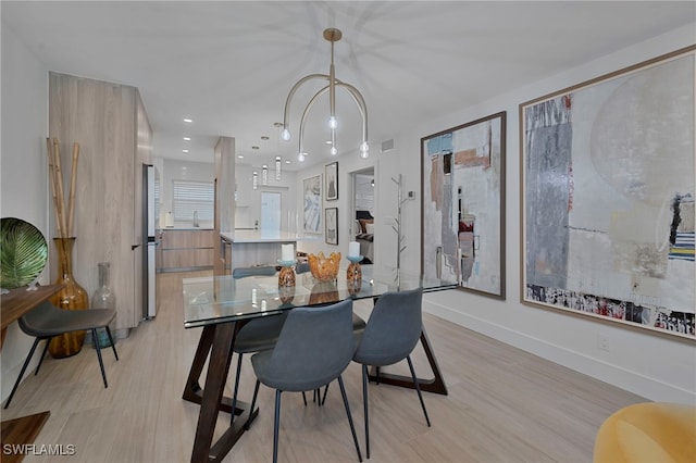 dining area featuring light wood-type flooring, visible vents, baseboards, and recessed lighting