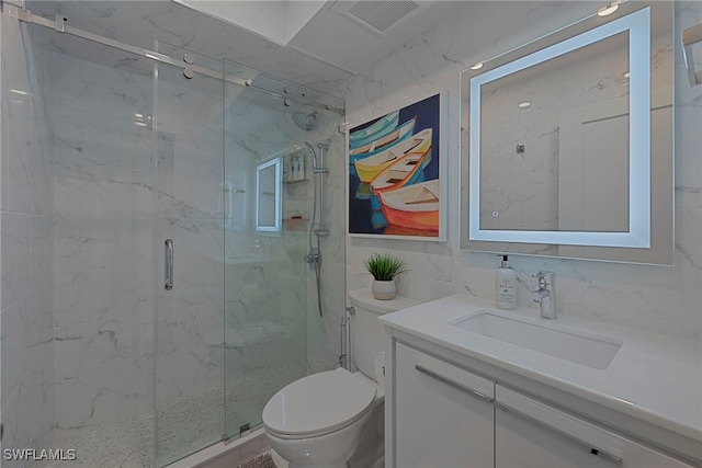 bathroom with a marble finish shower, visible vents, vanity, and toilet