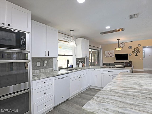 kitchen featuring white cabinetry, visible vents, and dishwasher