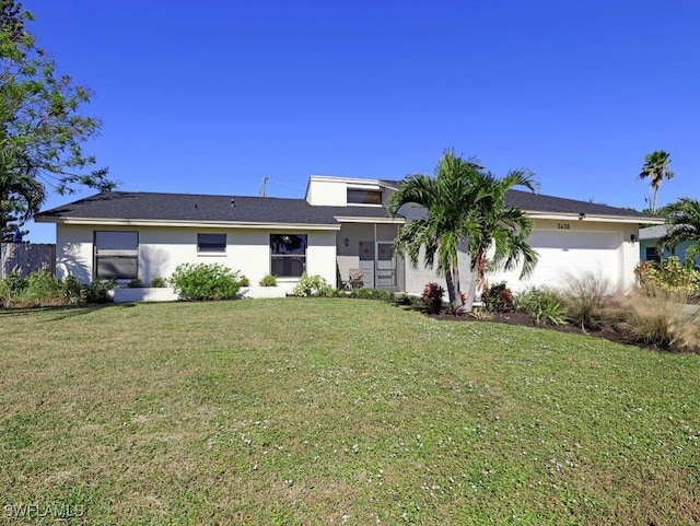 ranch-style home featuring an attached garage, a front lawn, and stucco siding