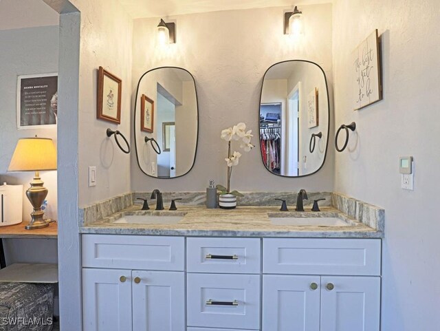 bathroom with a sink and double vanity