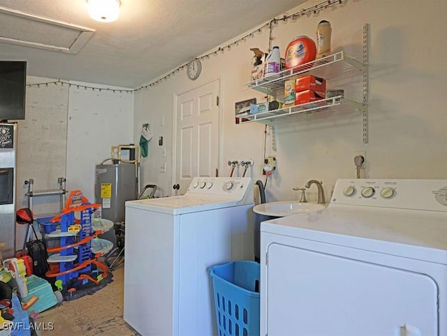 laundry room with laundry area, attic access, washer and clothes dryer, water heater, and a sink