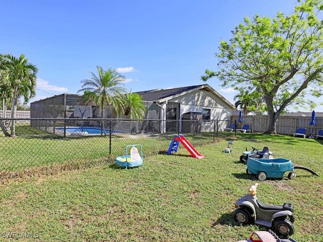 view of community with a lawn and fence