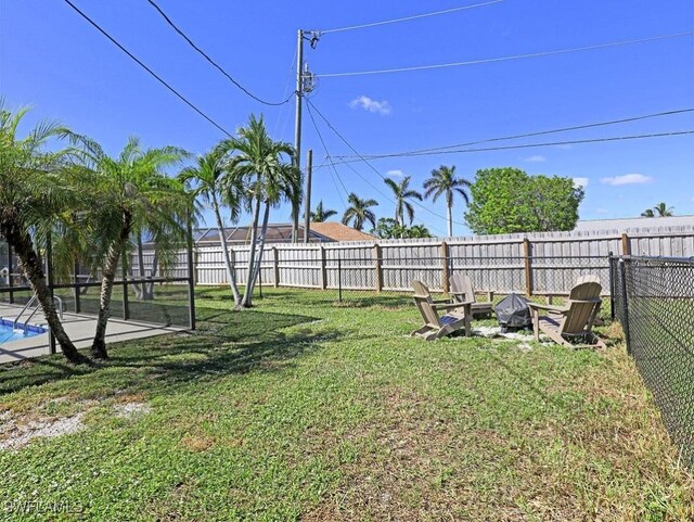 view of yard with an outdoor fire pit and a fenced backyard