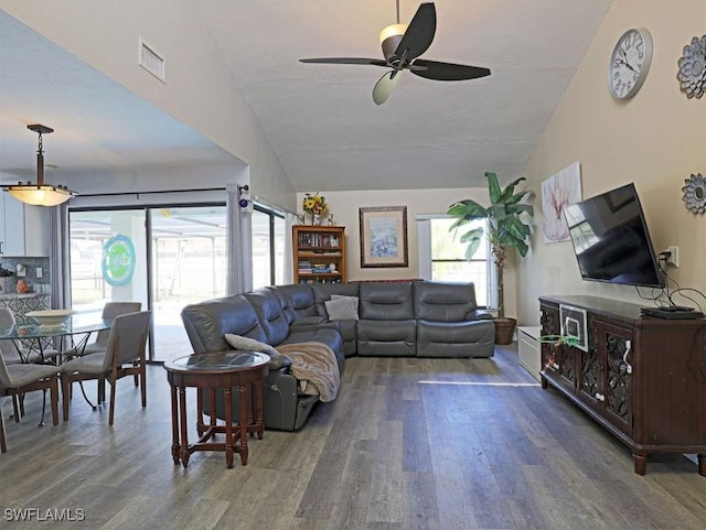 living room with lofted ceiling, visible vents, ceiling fan, and wood finished floors