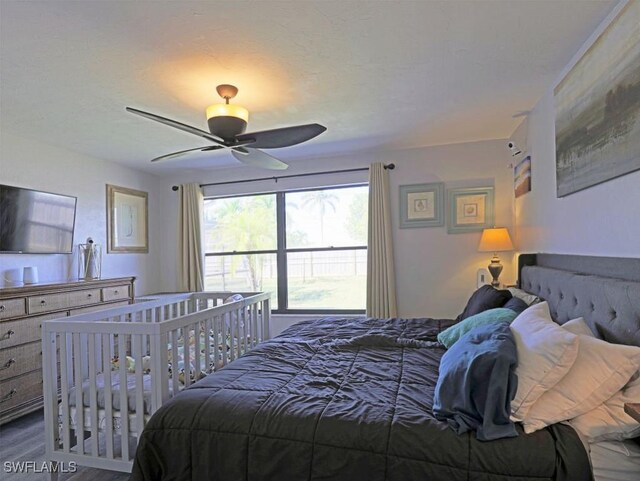 bedroom with wood finished floors and a ceiling fan