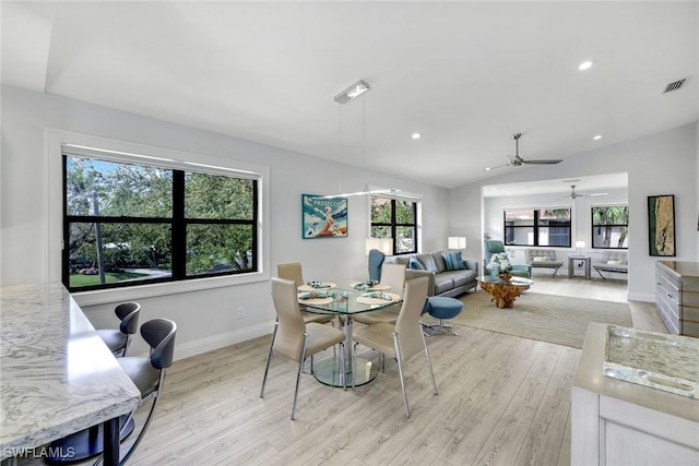 dining space with recessed lighting, visible vents, vaulted ceiling, light wood-type flooring, and baseboards