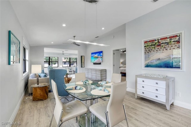 dining space with lofted ceiling, baseboards, light wood finished floors, and recessed lighting