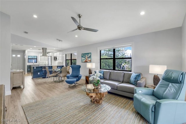 living room featuring light wood finished floors, recessed lighting, visible vents, a ceiling fan, and vaulted ceiling