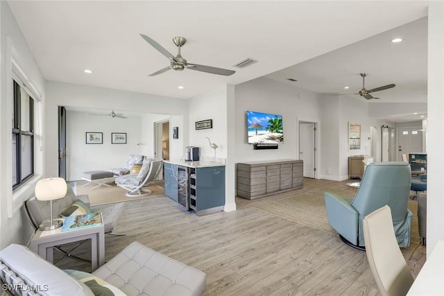 living room featuring ceiling fan, light wood-type flooring, and recessed lighting