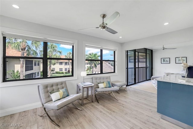 interior space with ceiling fan, recessed lighting, baseboards, and light wood-style floors