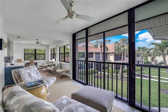 sunroom / solarium with visible vents and ceiling fan