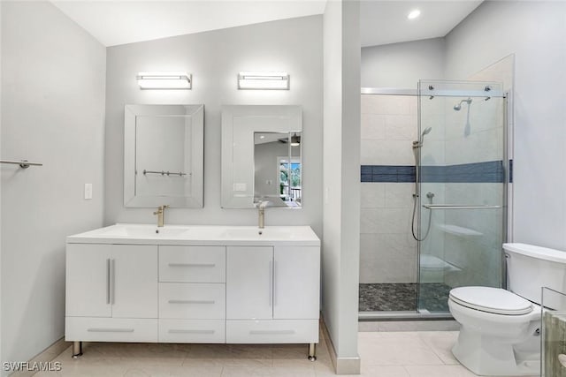 full bathroom featuring a stall shower, a sink, and toilet