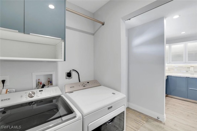 clothes washing area with light wood-style flooring, recessed lighting, laundry area, separate washer and dryer, and baseboards