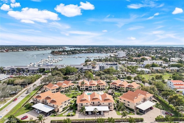 birds eye view of property with a water view and a residential view