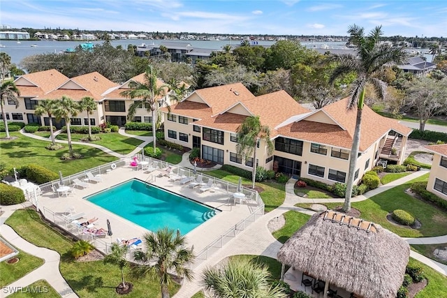 drone / aerial view featuring a water view and a residential view