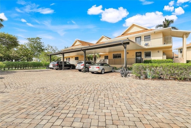 view of front of home featuring uncovered parking and stucco siding