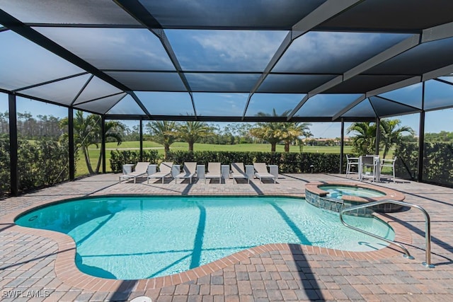 view of pool featuring a patio, a lanai, and a pool with connected hot tub