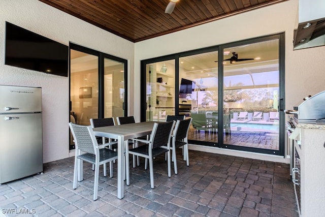 view of patio featuring exterior kitchen and outdoor dining area