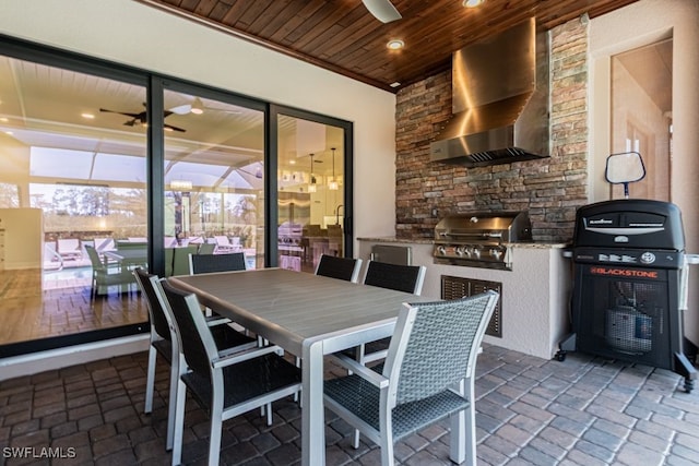 view of patio / terrace with an outdoor kitchen, grilling area, and outdoor dining space